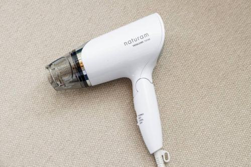 a white hair dryer sitting on top of a table at Beach House Villa Kashima in Kashima