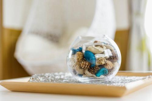 a glass jar filled with stuffed animals on a table at Beach House Villa Kashima in Kashima