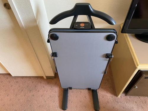 a suitcase is sitting in a room next to a door at Koriyama View Hotel in Koriyama