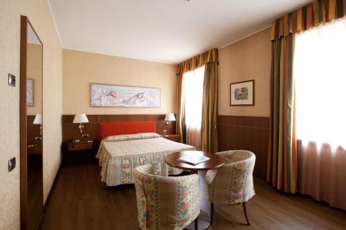 Postel nebo postele na pokoji v ubytování Palace Hotel Moderno