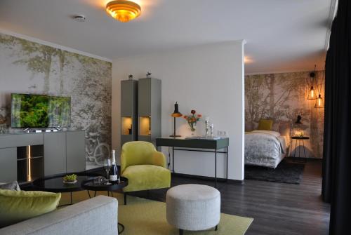 a living room with a couch and a bedroom at Ratskeller Wiedenbrück in Rheda-Wiedenbrück