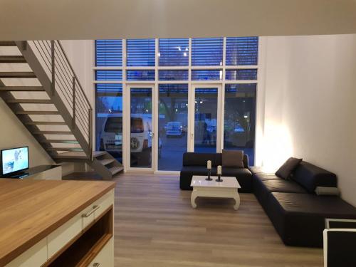 a living room with a couch and a table at WH Boardinghouse in Papenburg