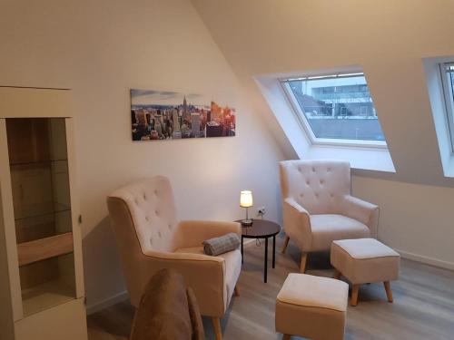 a living room with two chairs and a table at WH Boardinghouse in Papenburg