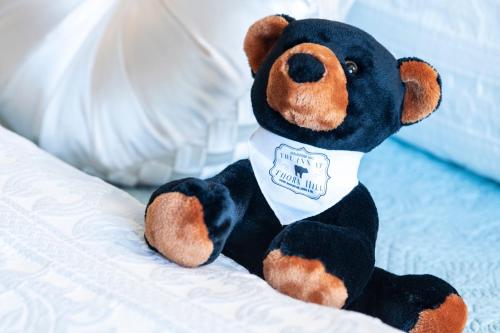a stuffed teddy bear sitting on a bed at The Inn at Thorn Hill in Jackson