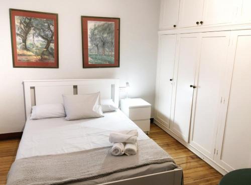 Un dormitorio con una cama blanca con toallas. en Clasico y funcional apartamento centro bilbao by urban hosts, en Bilbao