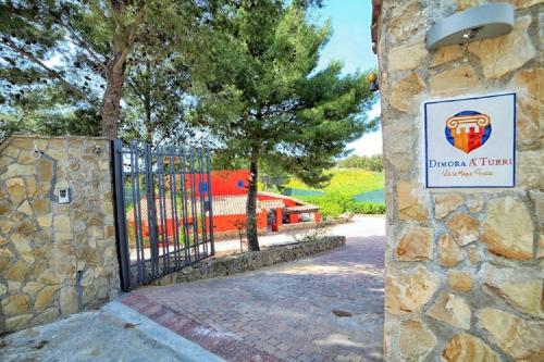 a gate at a park with a sign on it at Dimora A' Turri di GN Real Escapes in Ribera