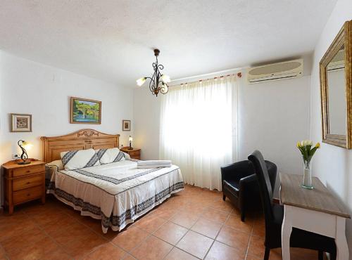 a bedroom with a bed and a desk and a table at Villa Iris - Plusholidays in Calpe