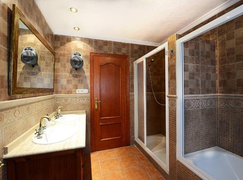 a bathroom with a sink and a shower and a tub at Villa Iris - Plusholidays in Calpe