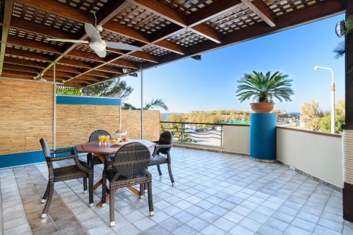 a patio with a table and chairs on a balcony at Xenios Dias Luxury Apartments With Sea View in Kato Daratso