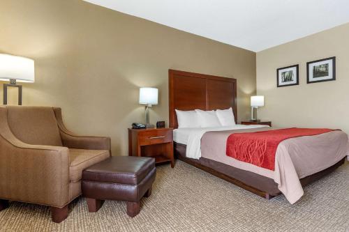 a hotel room with a bed and a chair at Comfort Inn Blythewood - North Columbia in Blythewood