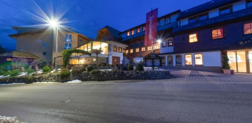 a building with a street in front of it at Hotel Engel - Familotel Hochschwarzwald in Todtnauberg