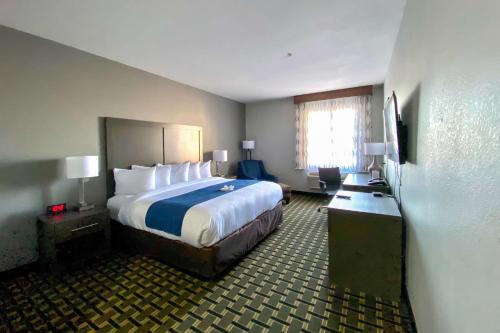 a hotel room with a large bed and a window at Comfort Inn Owasso – Tulsa in Owasso