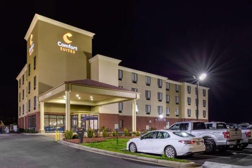 a hotel with cars parked in a parking lot at Comfort Suites Pelham Hoover I-65 in Pelham