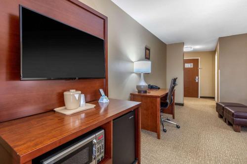 a hotel room with a large flat screen tv at Comfort Suites Pelham Hoover I-65 in Pelham