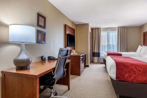 a hotel room with a desk and a bed at Comfort Suites Pelham Hoover I-65 in Pelham