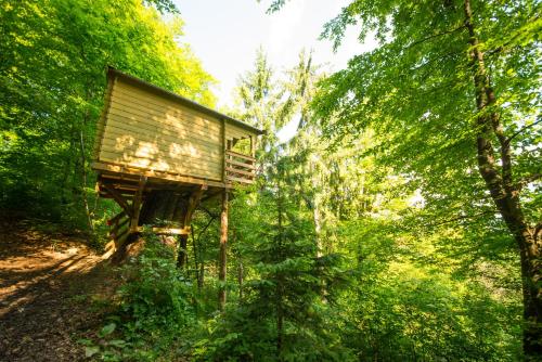 a tree house in the middle of a forest at Adventure Farm in Štore