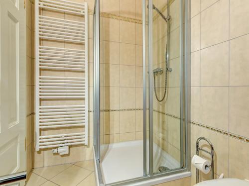 a bathroom with a shower with a glass door at Haus Meerblick - 10 in Ahlbeck