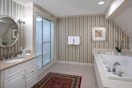 a bathroom with a tub and a sink and a mirror at The Inn at Thorn Hill in Jackson