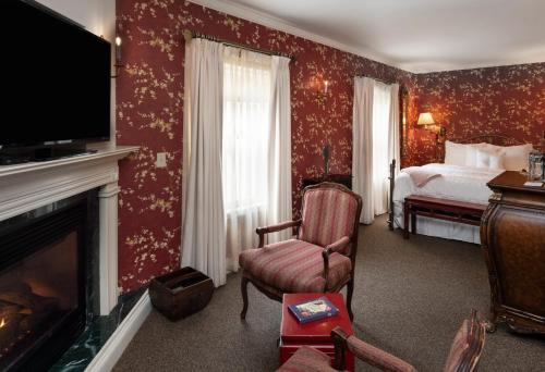 a room with a bedroom with a bed and a fireplace at The Inn at Thorn Hill in Jackson