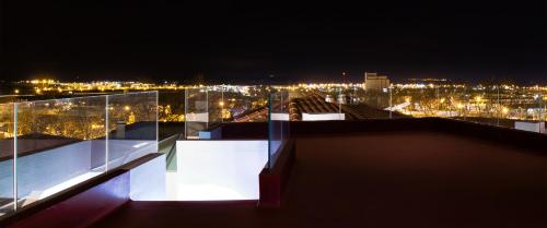 a view of a city at night with lights at Evora Olive Hotel in Évora
