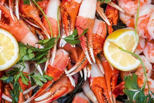 a pile of shrimp with lemon slices on top at InterContinental - Los Angeles Downtown by IHG in Los Angeles