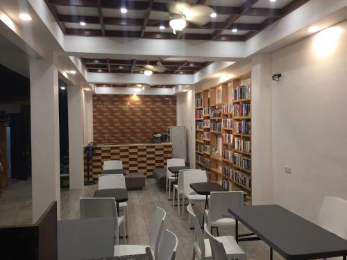 a room with tables and chairs in a library at Monallan Boracay Hotel in Boracay