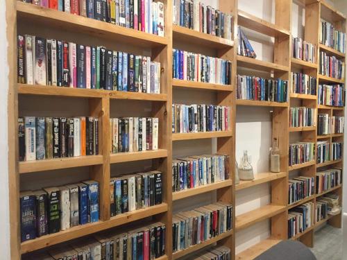 a row of wooden bookshelves filled with books at Monallan Boracay Hotel in Boracay