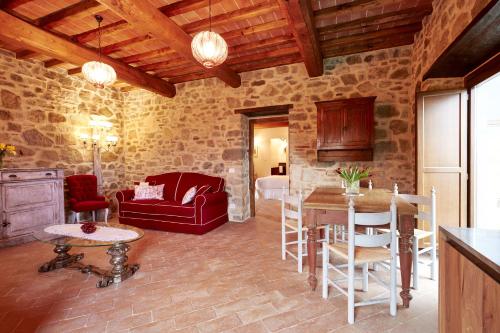 ein Wohnzimmer mit einem roten Sofa und einem Tisch in der Unterkunft Podere di Moiata in Campestri