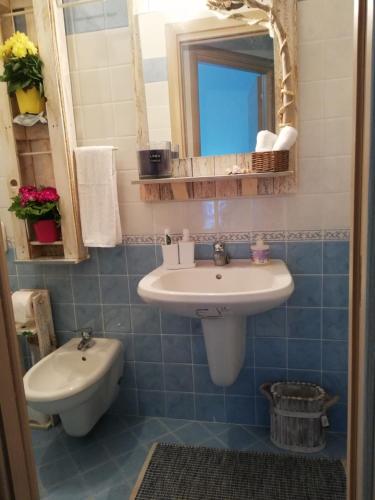 a bathroom with a sink and a mirror at Le Torrette di Anna - Tropea in Briatico