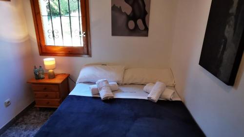 a bedroom with a bed with towels on it at VILLAS COSETTE - Villa Martina in Caldes de Malavella