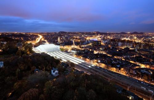 an aerial view of a city at night at Studio des jardins suspendus in Liège