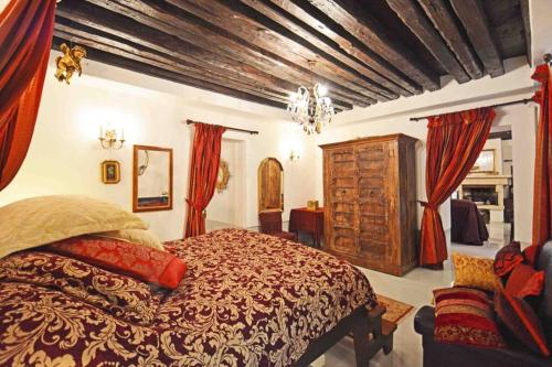 a bedroom with a large bed with red curtains at Zattere Cottage close to Guggenheim in Venice