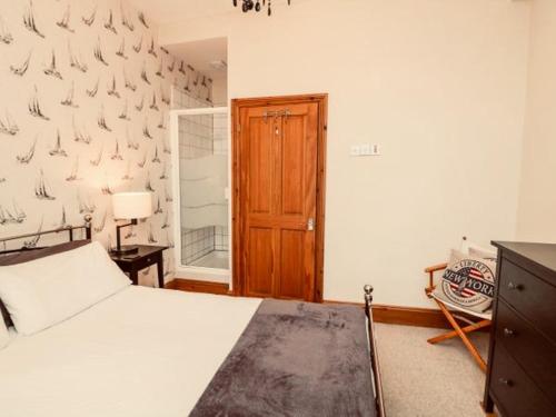 - une chambre avec un lit et une porte en bois dans l'établissement Durnford St- Amazing location - free WiFi, à Plymouth