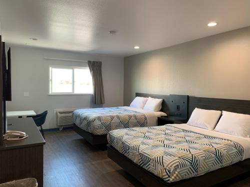 a hotel room with two beds and a window at Motel 6 Bullhead City, Az - Laughlin in Bullhead City