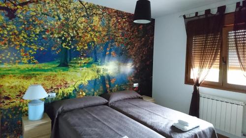 a bedroom with a bed with a painting on the wall at Zendoira in Palas de Rei