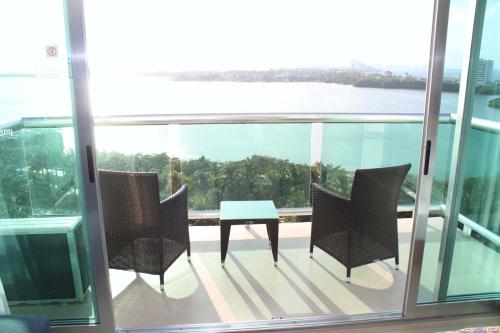 a balcony with a table and chairs on a building at Ocean Dream Cancun by GuruHotel in Cancún