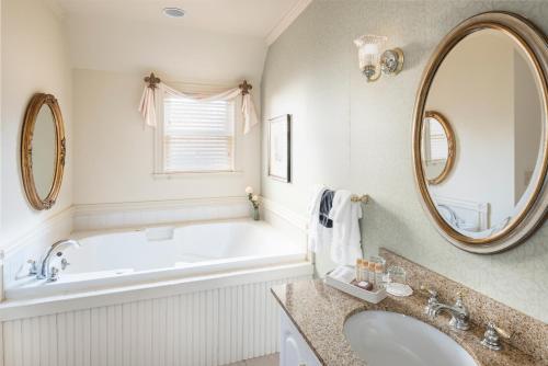 a bathroom with a tub and a sink and a mirror at The Inn at Thorn Hill in Jackson