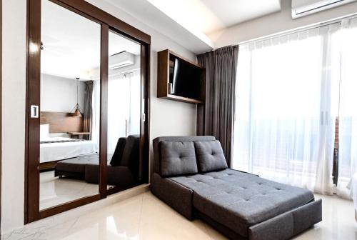a bedroom with a chair and a mirror at Ocean Dream Cancun by GuruHotel in Cancún