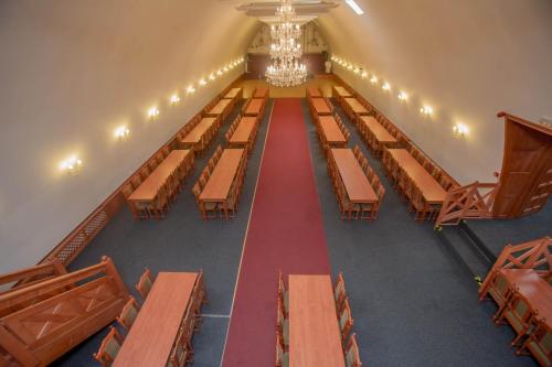 an empty room with wooden tables and chairs at Hotel Koliba in Litoměřice