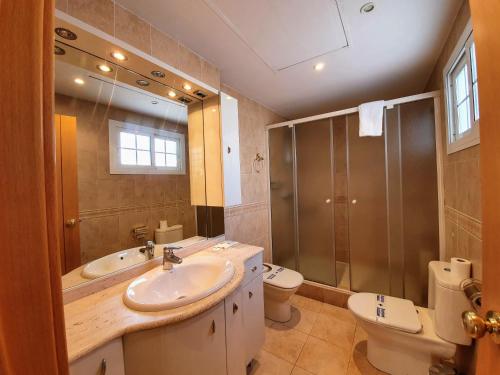 a bathroom with a sink and a shower and a toilet at Triana Luxury Home in Seville