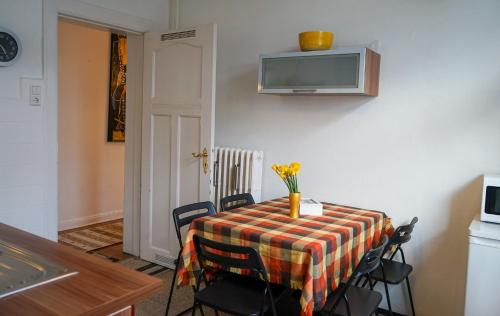 a dining room with a table with a vase of flowers on it at Wohnung in Lüneburg in Lüneburg