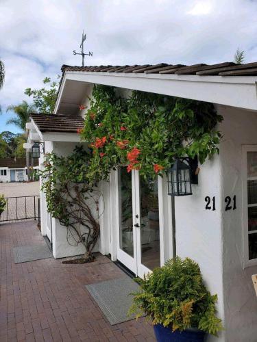 a white house with a plant on the side of it at Marina Beach Motel in Santa Barbara