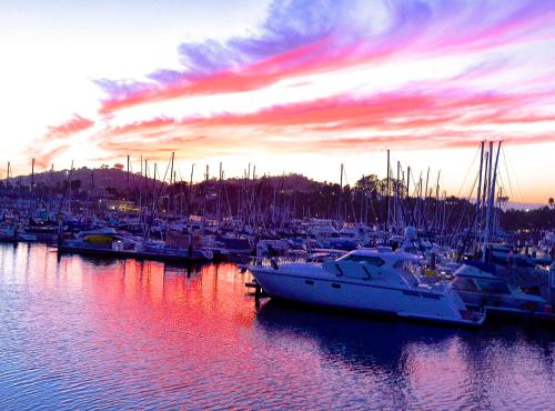 a group of boats docked in a marina at sunset at Marina Beach Motel in Santa Barbara