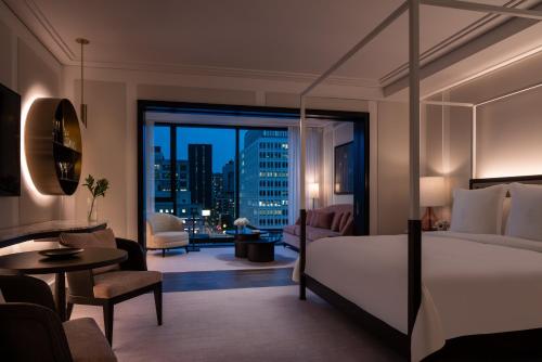 Four Seasons Hotel Montreal في مونتريال: غرفة نوم بسرير وإطلالة على مدينة