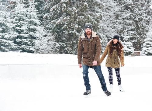 a man and a woman standing in the snow at The Inn at Thorn Hill in Jackson
