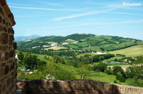 a view of the rolling hills from a castle turret at Nidastore Holidays in Arcevia