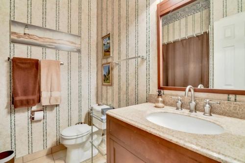 a bathroom with a sink and a toilet and a mirror at PRIVATE POOL w/Full Amenities by BLD & Joe Pool LK in Mansfield