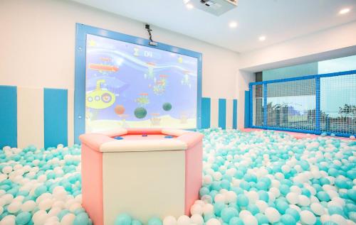 a room with a large screen filled with eggs at Grand Bay Hotel Zhuhai in Zhuhai