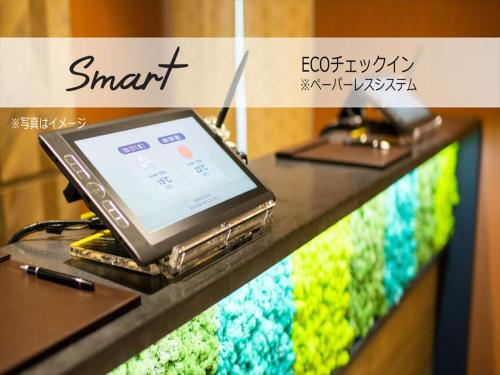 a laptop computer sitting on top of a counter at Super Hotel Mitazono Sendai Airport in Natori