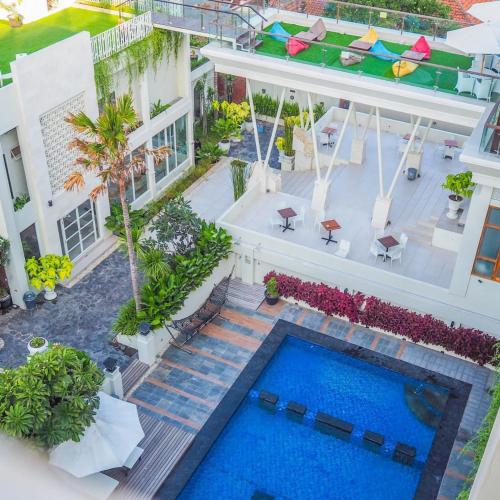 an aerial view of a building with a swimming pool at Luminor Hotel Banyuwangi By WH in Banyuwangi